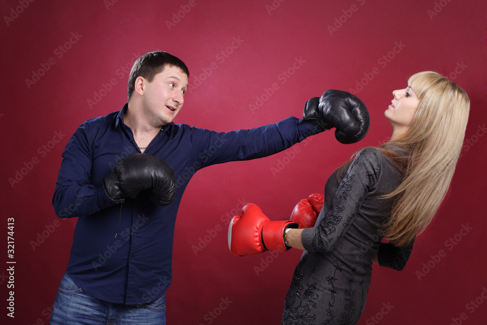 attractive family couple in boxing gloves on red attractive family couple in boxing gloves on red