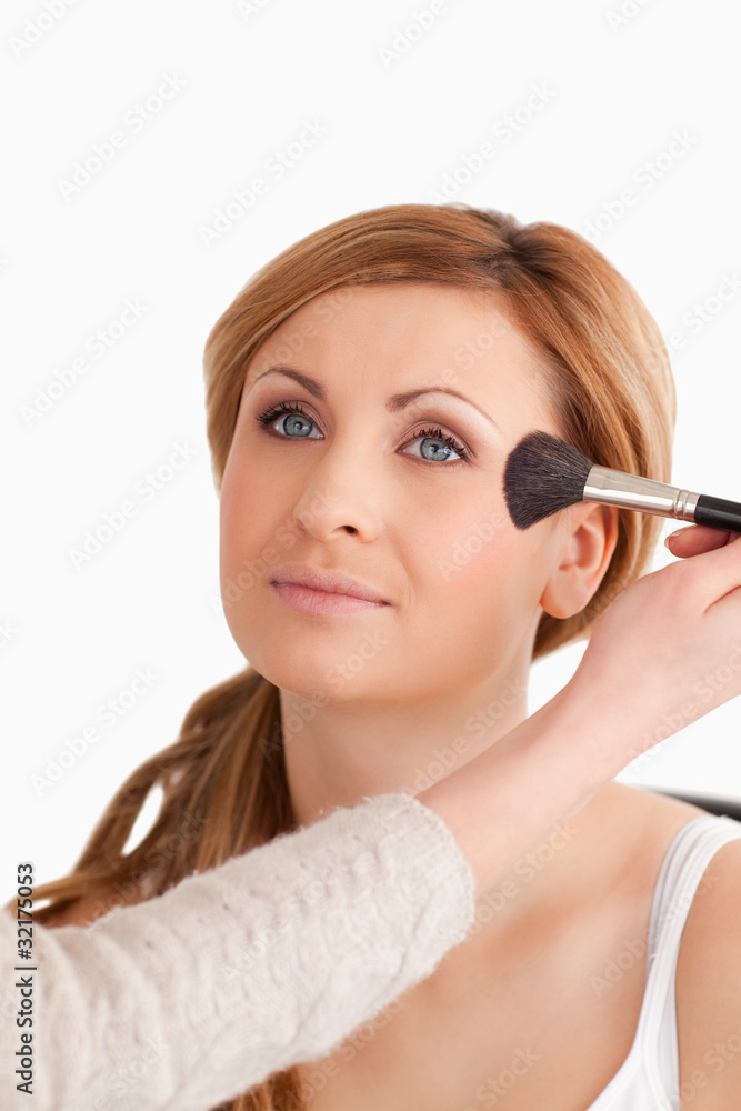 Make-up artist applying make up to an attractive woman Make-up artist applying make up to an attractive woman