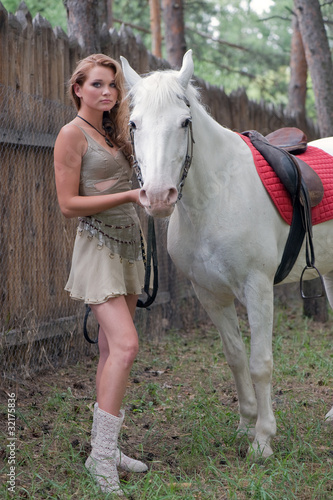 Rural pretty girl with a stallion