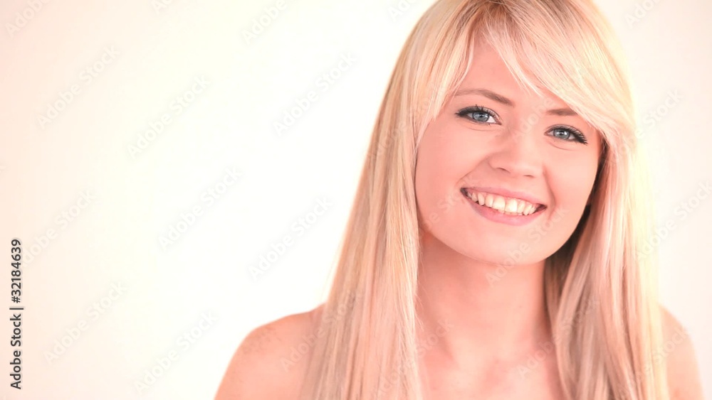 Attractive blond-haired woman posing and blowing a kiss Attractive blond-haired woman posing and blowing a kiss