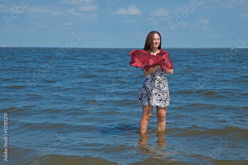 young woman walks on the beach photo