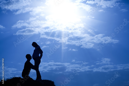 silhouette of man and pregnant woman