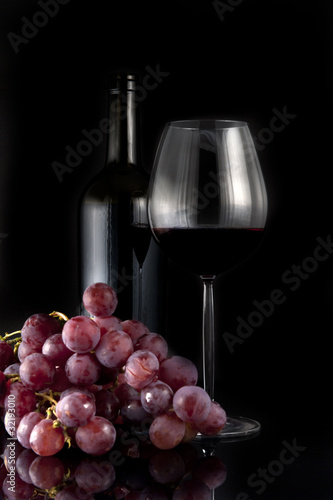 Glass of red wine and grapes