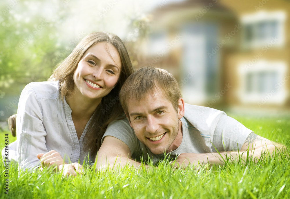 Happy Couple near their Home. Smiling Family outdoors. Happy Couple near their Home. Smiling Family outdoors.