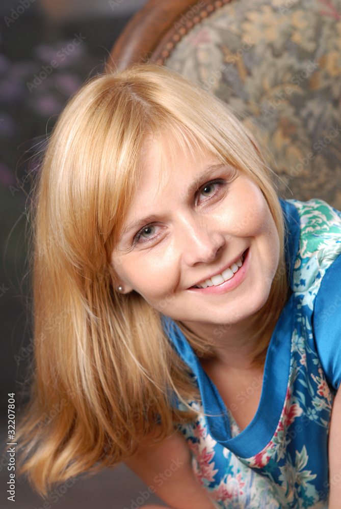 Natural portrait of attractive woman sitting on the chair Natural portrait of attractive woman sitting on the chair