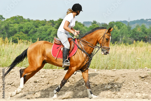 Girl is riding a Akhal-Teke horse