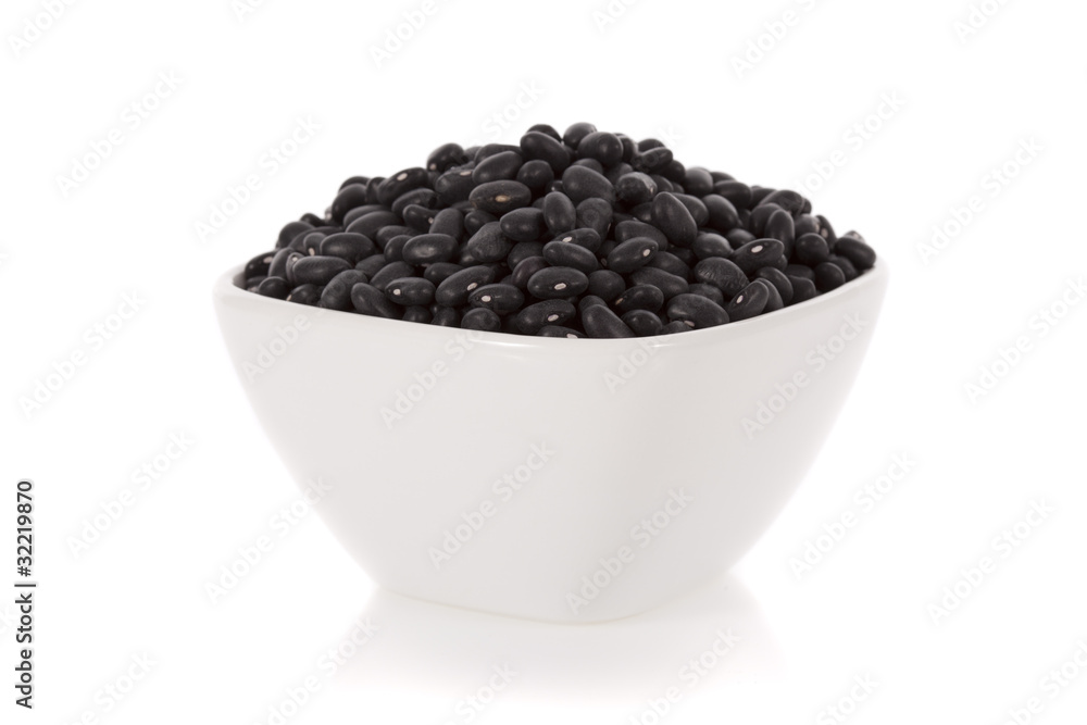 Black turtle beans in a bowl isolated on a white background. Black turtle beans in a bowl isolated on a white background.