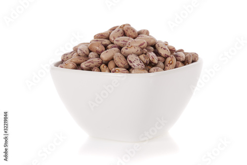 Pinto beans in a bowl isolated on a white background.