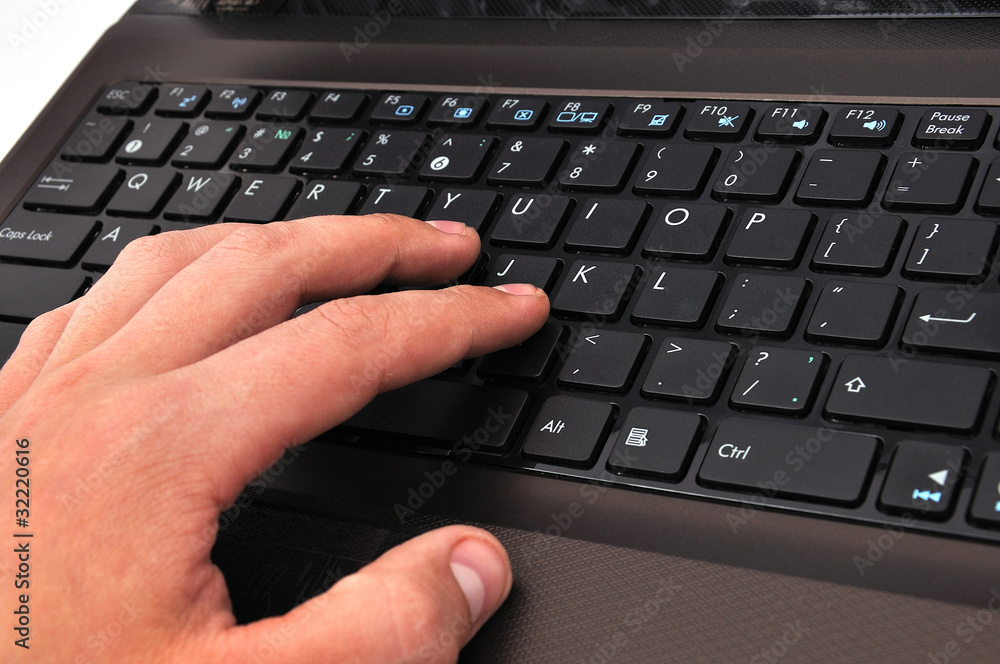 hand on a laptop hand on a laptop