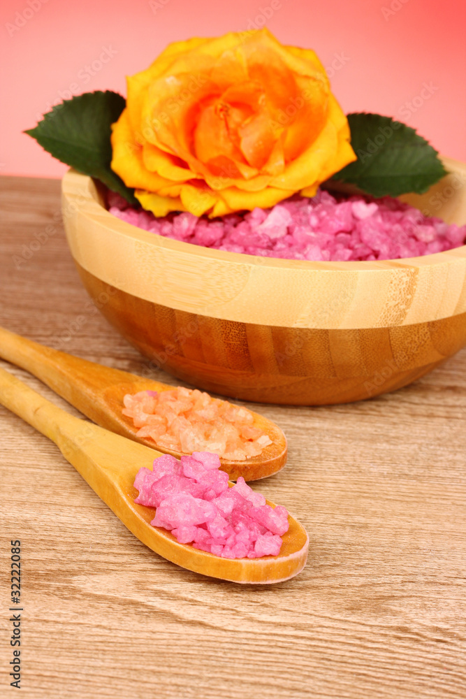 Bath aromatic salt, rose and sea stars on wooden background