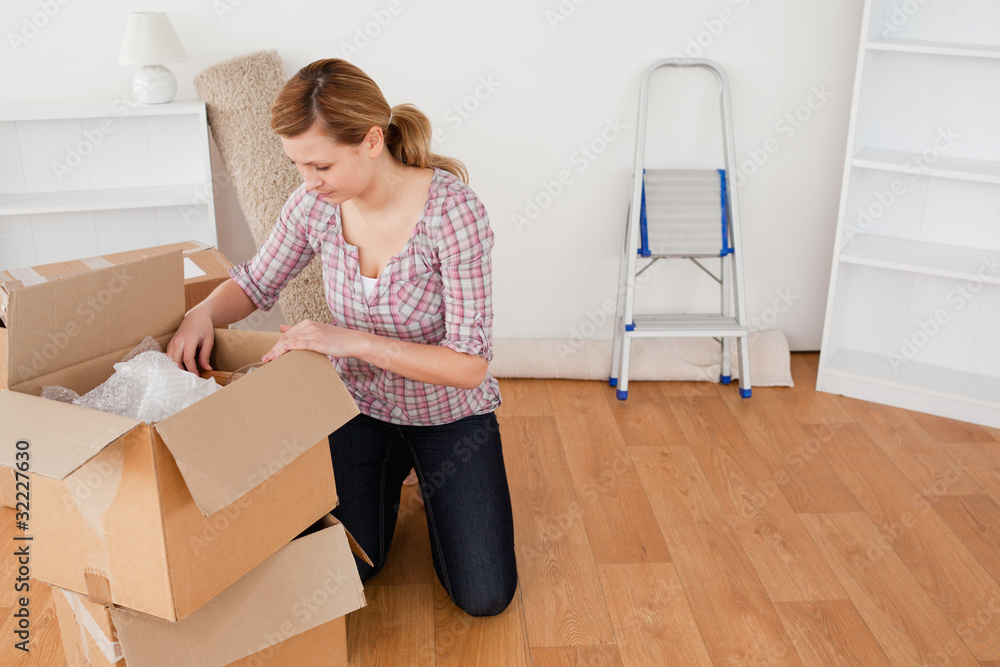 Blond-haired woman preparing to move house Blond-haired woman preparing to move house