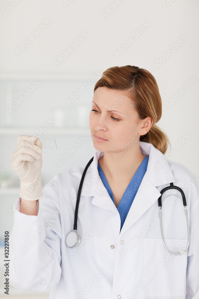 Female scientist looking at a microscope slide Female scientist looking at a microscope slide