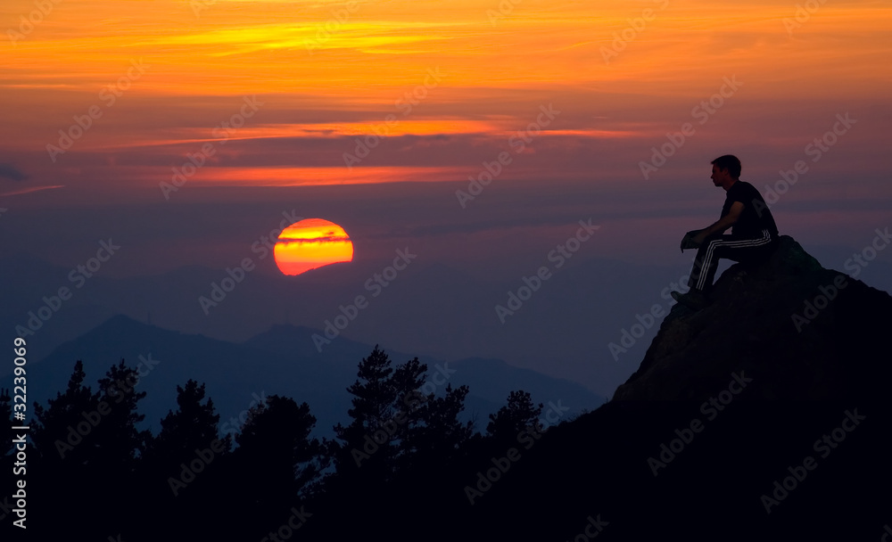 Man silhouette on the sunset background