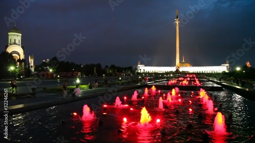 obelisk and illuminated fountains at night