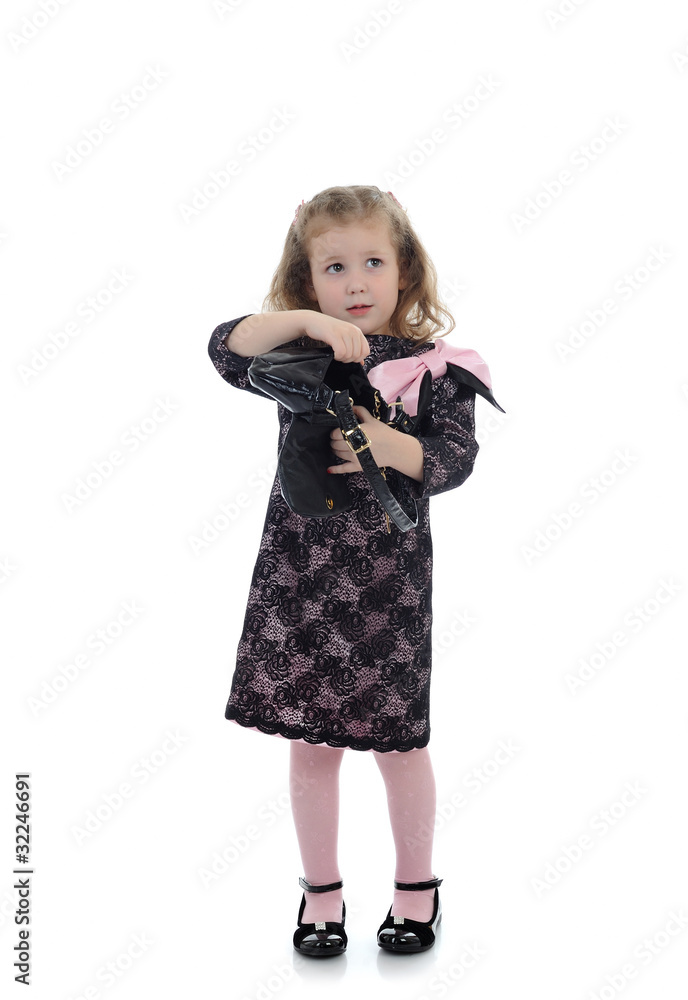 Pretty little child girl in black elegant party dress with empty Pretty little child girl in black elegant party dress with empty