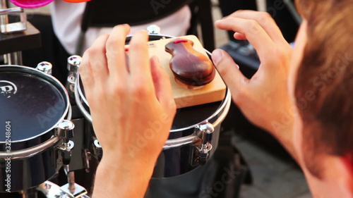 man of brass band plays castanets sitting on summer day photo