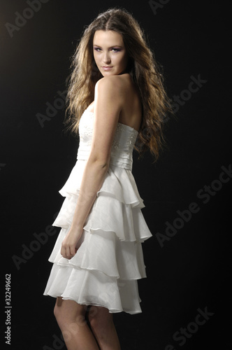 attractive young woman posing in a lovely dress