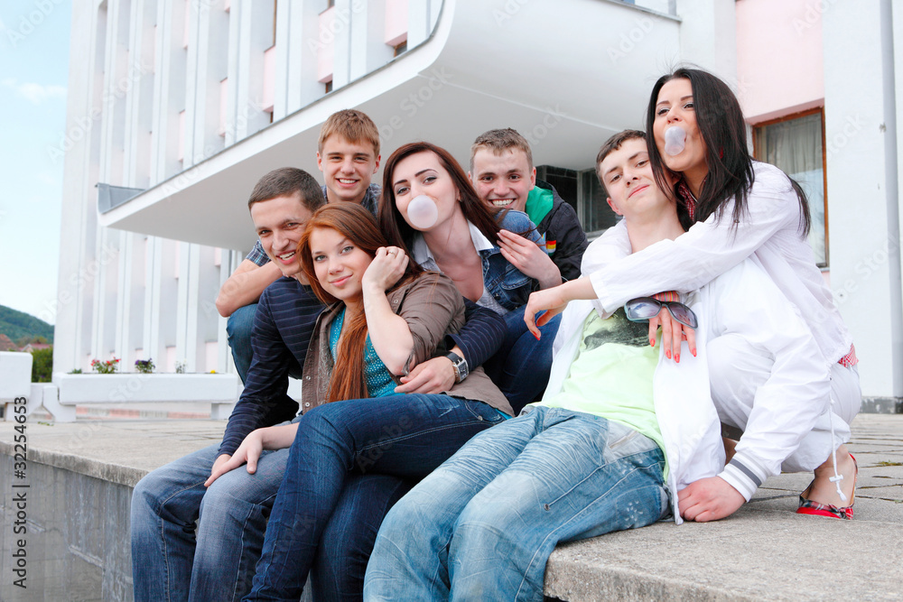 Group of male and female students against the background an acad Group of male and female students against the background an acad