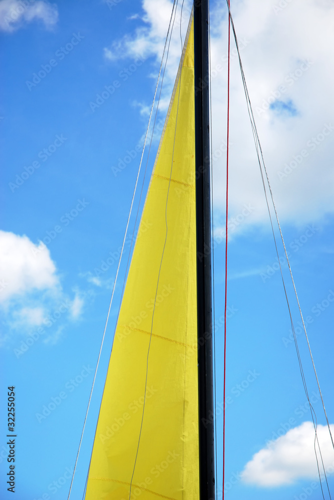 yellow sail and blue sky - obrazy, fototapety, plakaty 