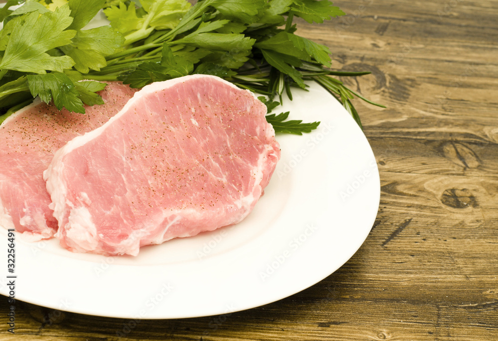 Raw pork chops with parsley