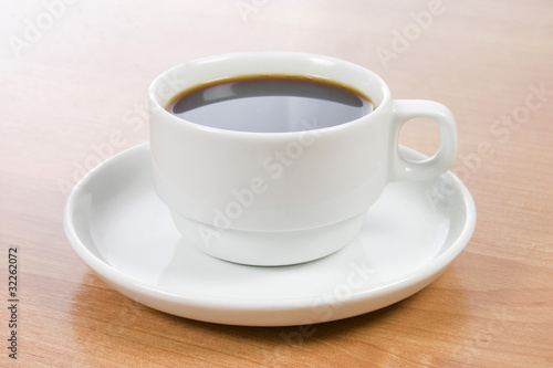 Cup of black coffee on a wooden table