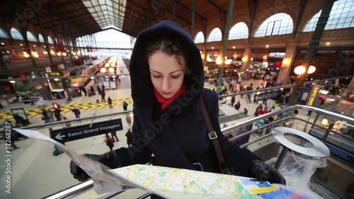 woman looks at map in Paris North Station