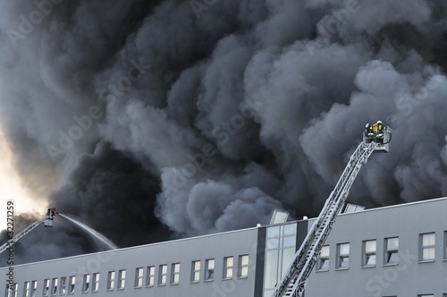 Firefighters fighting a fire at a warehouse