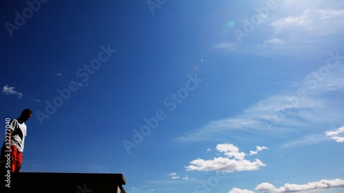 young man makes back flip, sportsman trains on outdoor photo