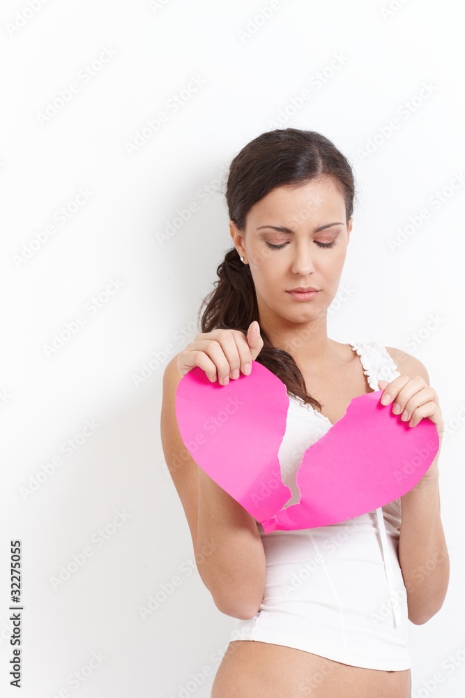 Heart-broken woman with a paper heart Heart-broken woman with a paper heart