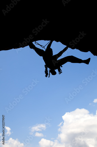 Rock climber silhouette in a sunny day