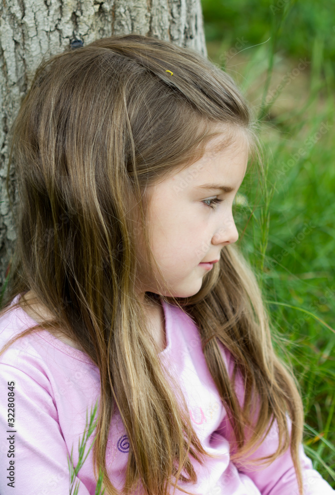 Worried little girl on grass Worried little girl on grass