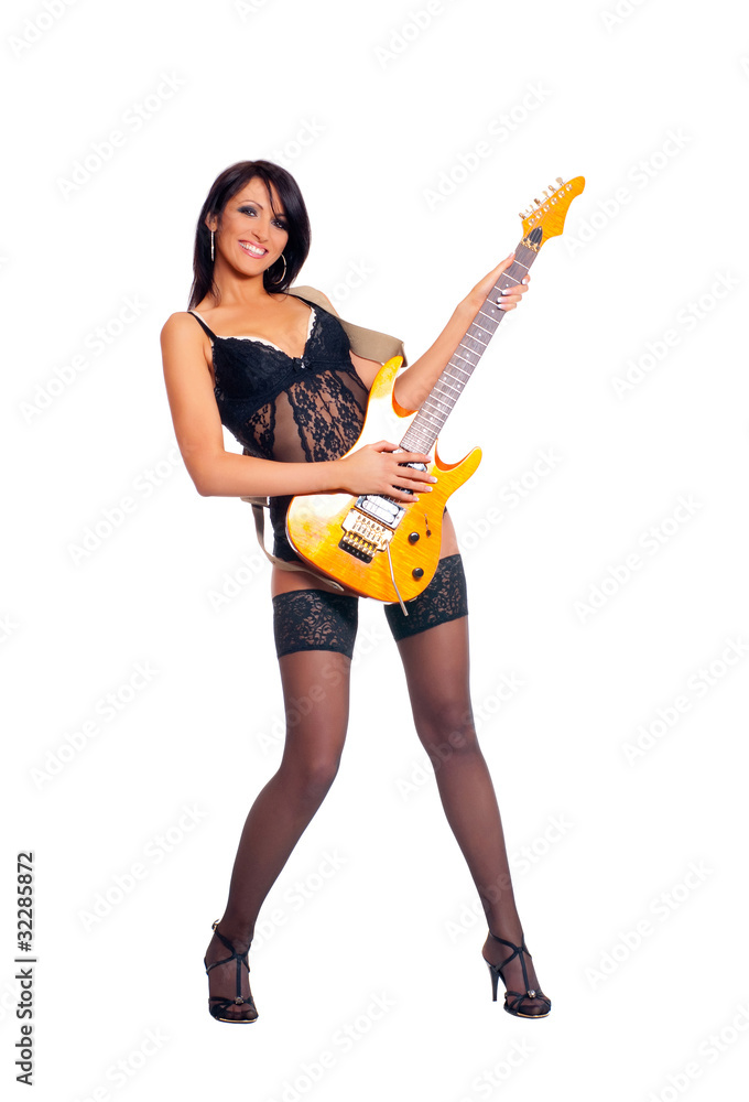 A sexy female rockstar in erotic lingerie with a yellow guitar A sexy female rockstar in erotic lingerie with a yellow guitar