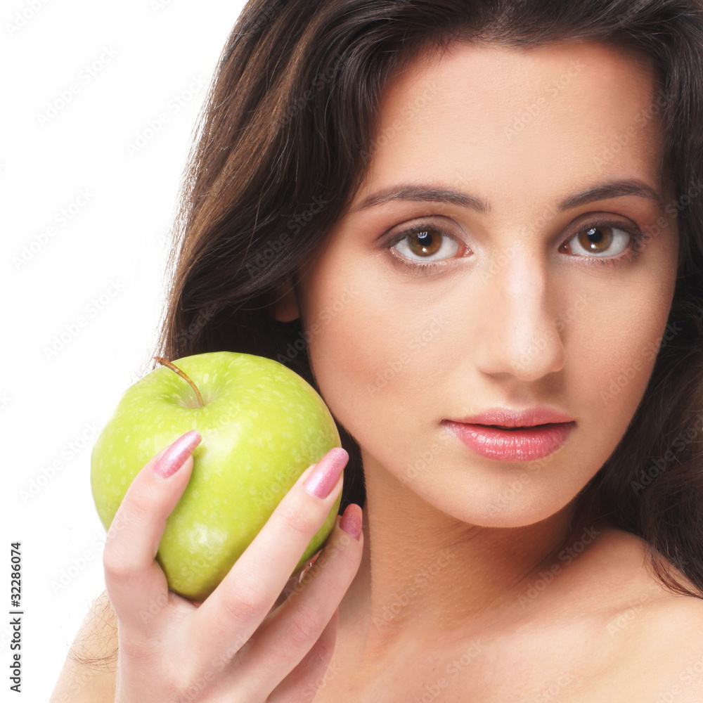 Portrait of a young and cute woman with a fresh green apple