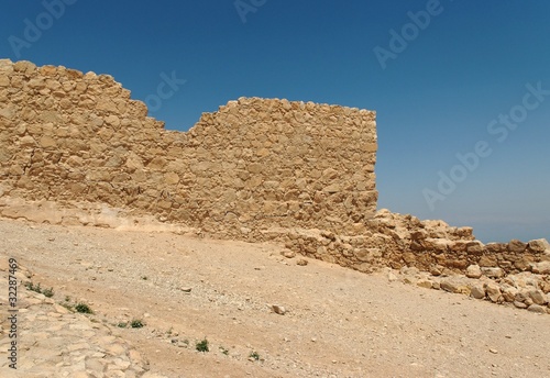 Jagged wall of ancient fortress ruin in the desert