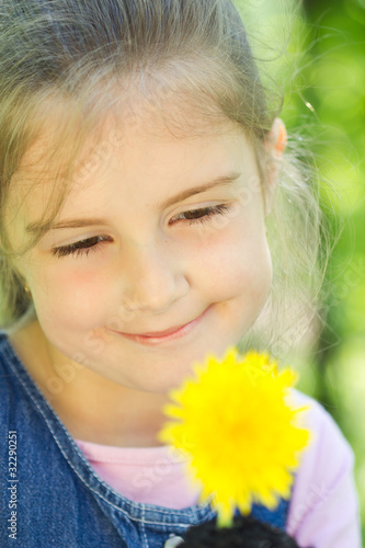 Little girl with yellow dandelion