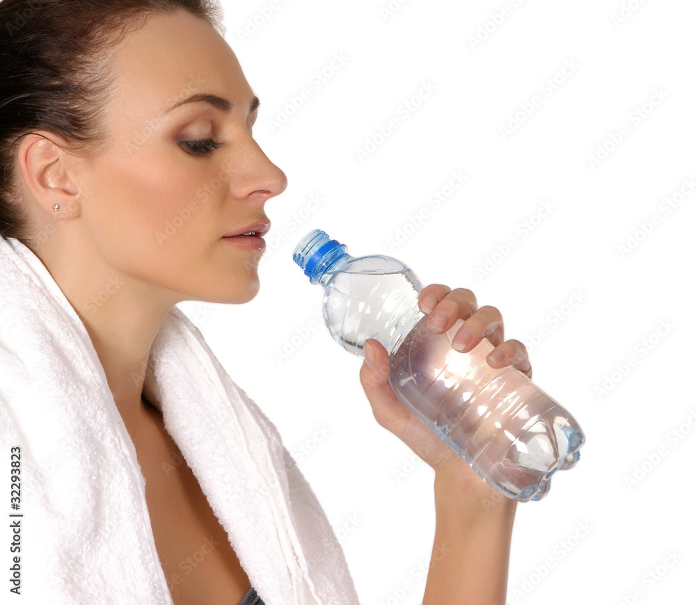A young and fit Caucasian woman is drinking fresh water A young and fit Caucasian woman is drinking fresh water