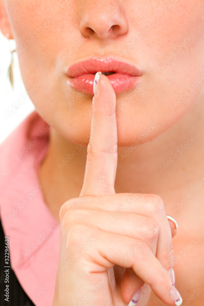 Closeup of business woman with finger at mouth. Shh gesture. Closeup of business woman with finger at mouth. Shh gesture.