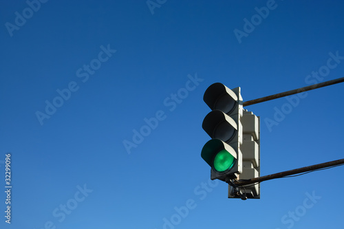 Green Traffic Light isolated on the Blue Sky