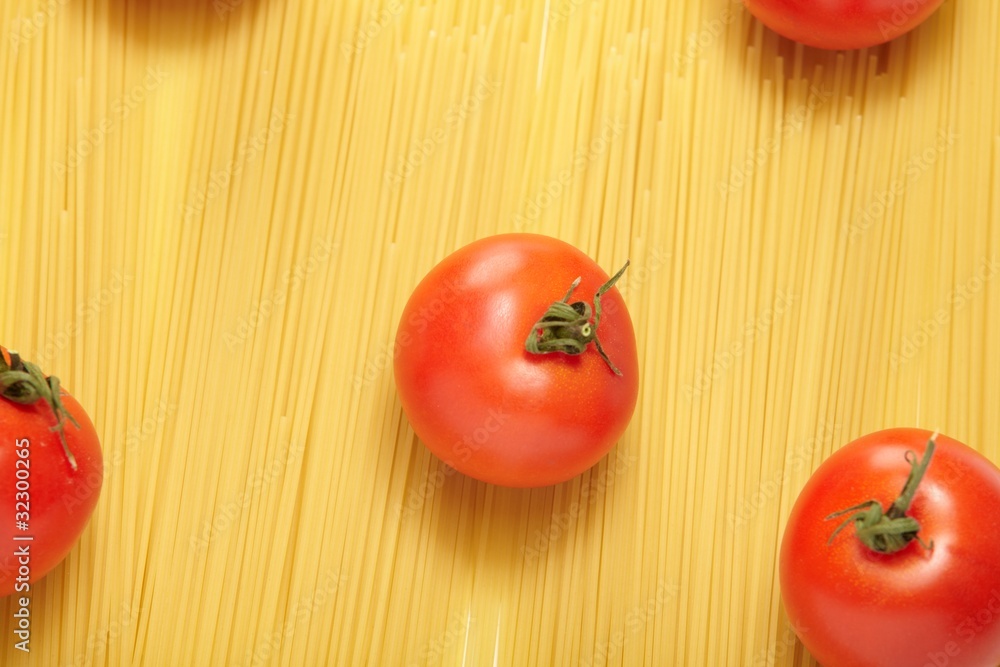 Raw spaghetti and fresh tomatoes Raw spaghetti and fresh tomatoes