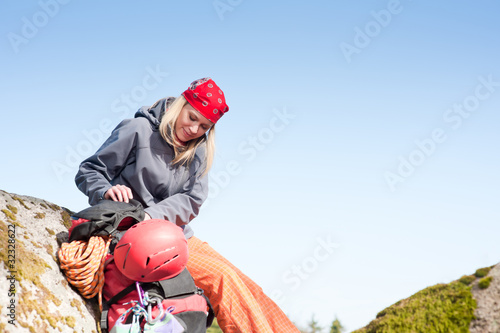Active woman rock climbing relax with backpack © CandyBox Images