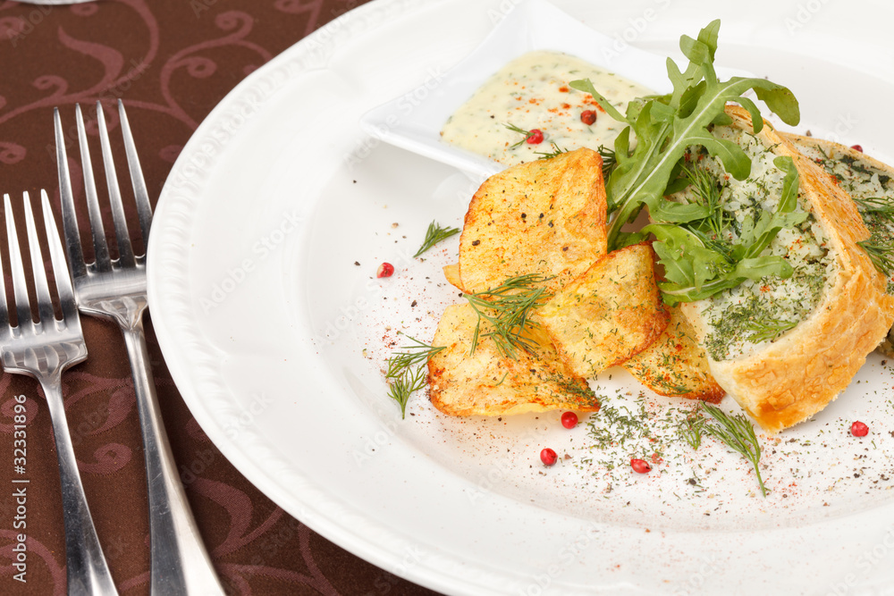 fish pie with sauce and potato chips