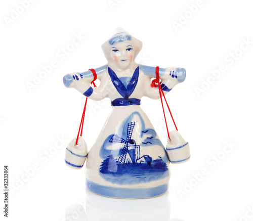 Dutch statue of milkmaid over white background