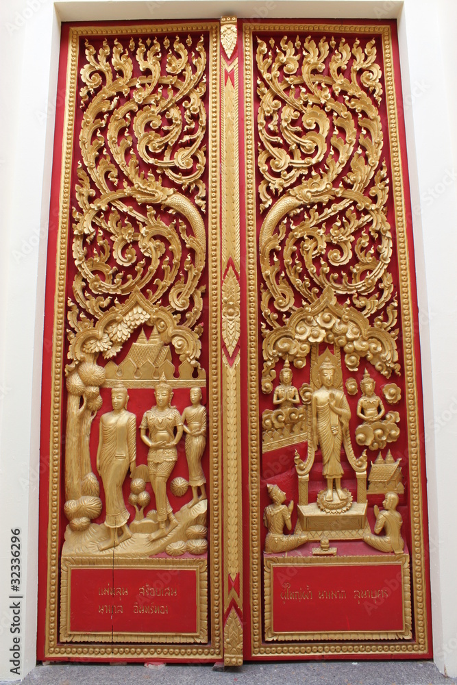 Thai art carving and painting on wooden window of temple