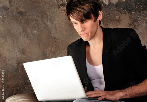 Happy businessman using laptop