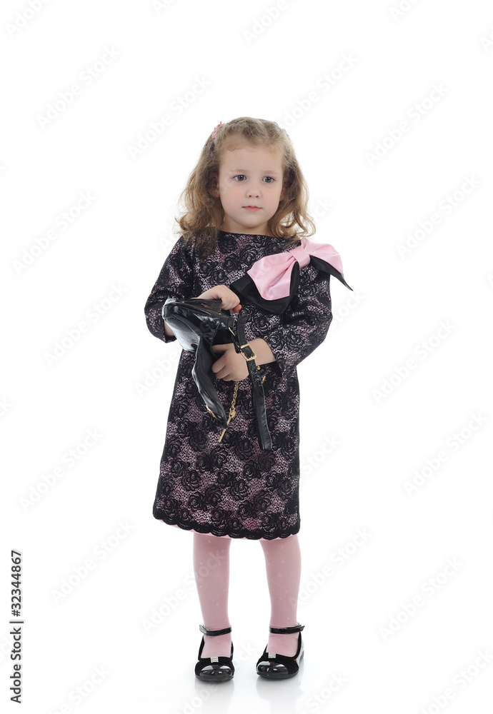Pretty little child girl in black elegant party dress with empty Pretty little child girl in black elegant party dress with empty