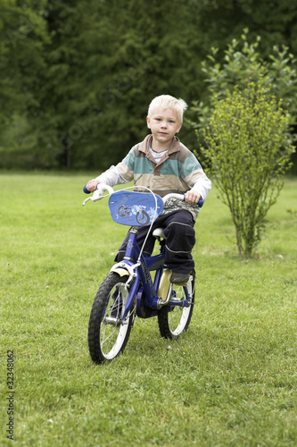 young boy bicyclist in green