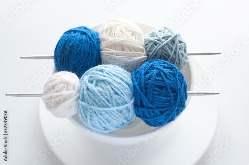 Colored balls of wool for knitting and needles