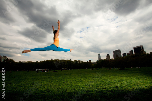 Young pretty woman in Central Park doing yoga