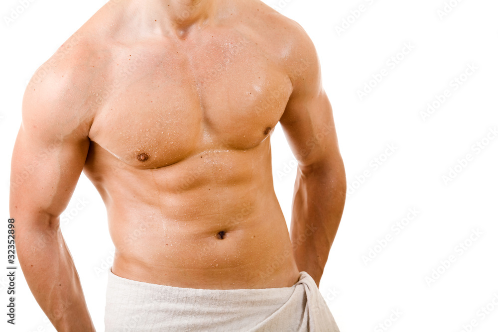 Wet muscular sexy man wrapped in the towel, isolated on white
