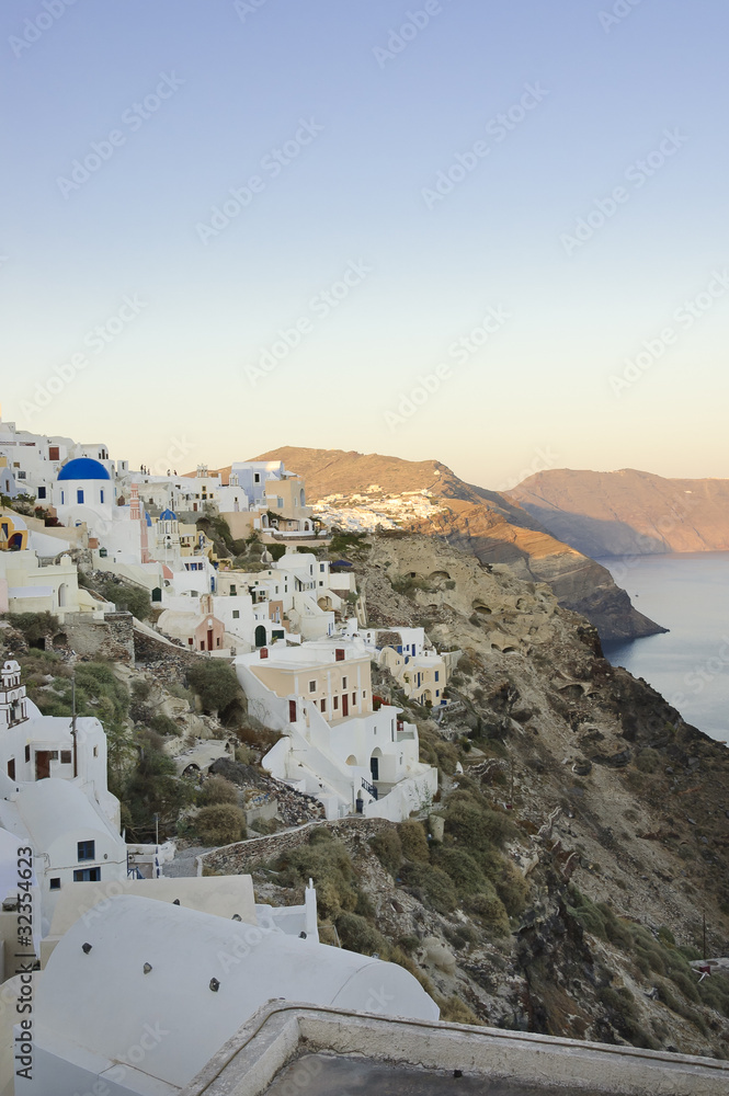Pastel colored houses over the caldera in Oia, Greece